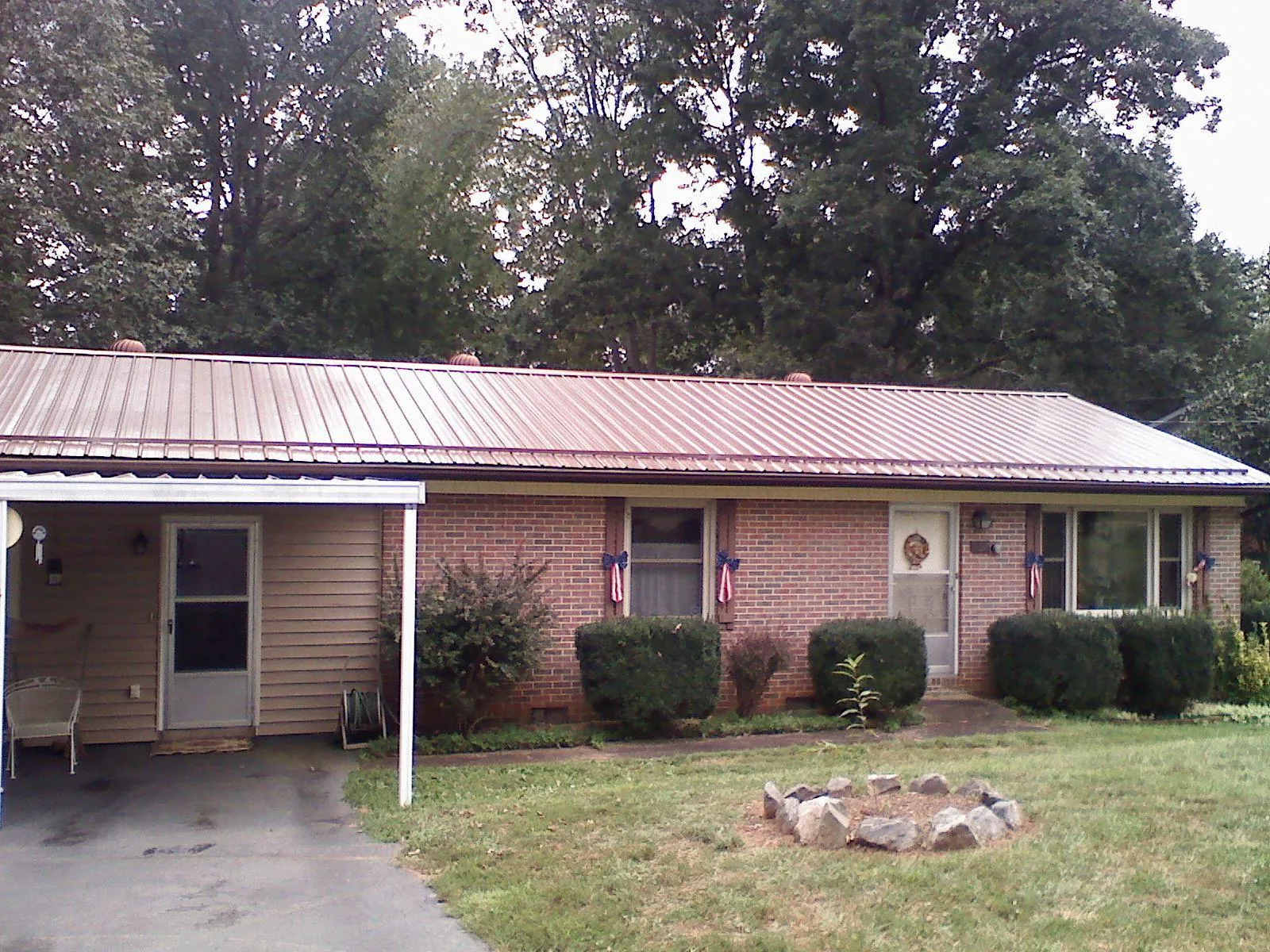 Bronze metal roof and carport on a brick ranch home — Roof Repair work by our crew in Monroe Township